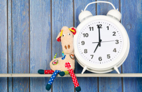 Stuffed animal giraffe and clock for bedtime